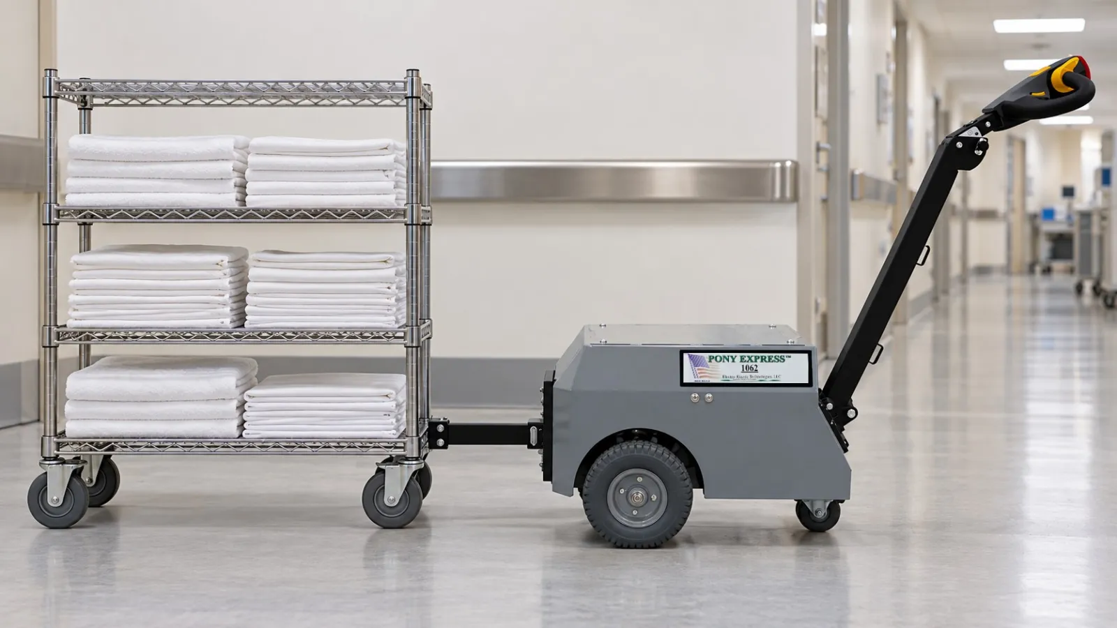Pony Express 1062 electric tugger with a linen shelf cart pinned to its rear hitch plate in a hospital hall (illustration)